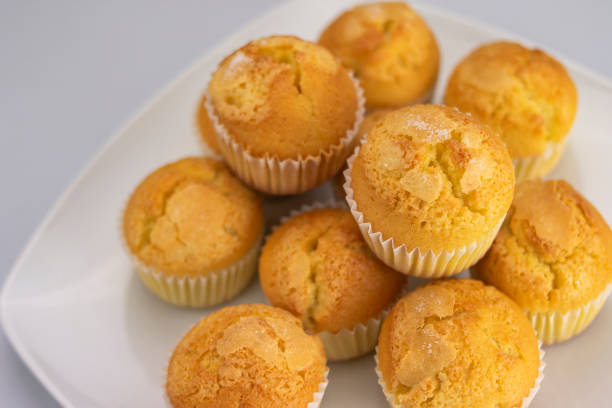 istock Golden muffins or cupcakes with white sugar on a serving dish freshly baked and cooked 1201762683