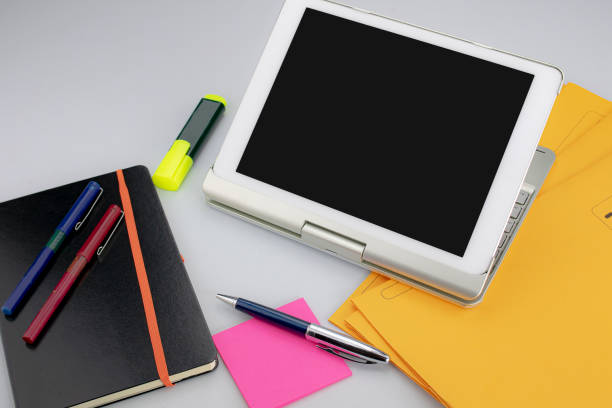 istock Markers with a digital tablet, sticky note pad, ball pens and folders and subfolders to archive and save documents and files 1201762755
