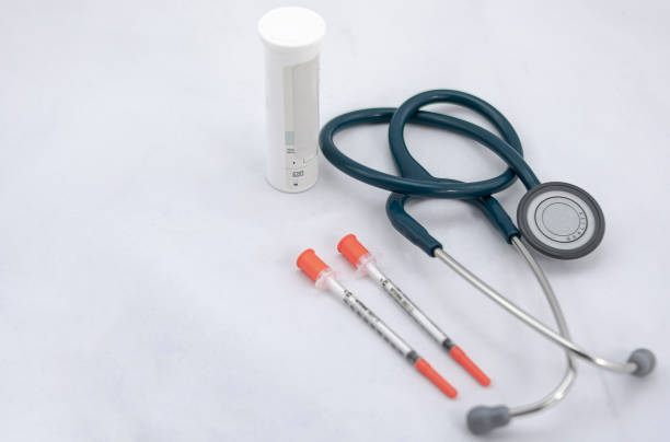 istock stethoscope, two syringes with cover and medicine bottle 1201763084