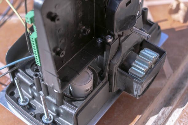 istock An electric engine is showed while is being installed and connected to the sliding door 1201765269