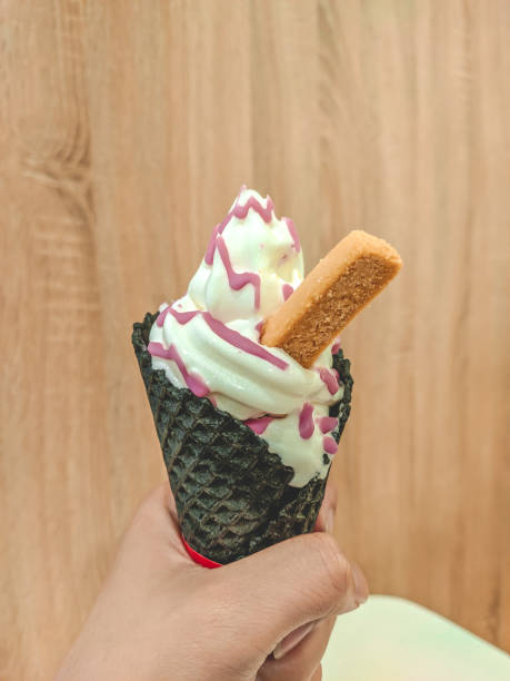 istock Hand Holding White Vanilla Ice Cream Cone 1201777495