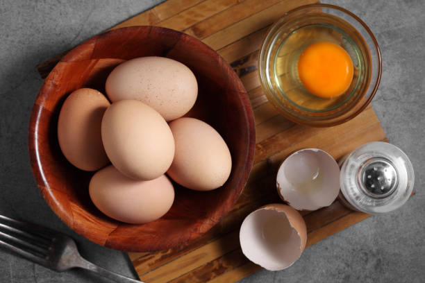 istock Group of of raw chicken eggs on rustic background, Ingredient for Scrambled eggs in loft style kitchen 1201777543