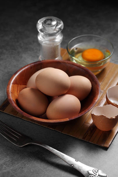 istock Group of of raw chicken eggs on rustic background, Ingredient for Scrambled eggs in loft style kitchen 1201777545