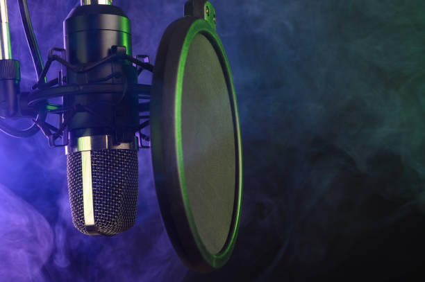 istock close-up. Studio condenser microphone Radio, vocals, colored smoke podcasts. Copy space. 1201779576