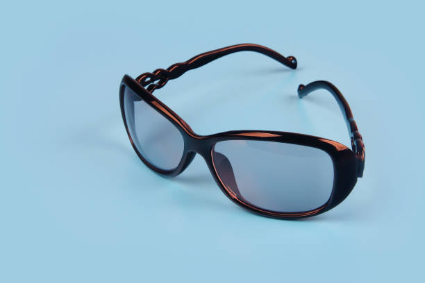 istock Women's black sunglasses isolated on blue background 1201781809