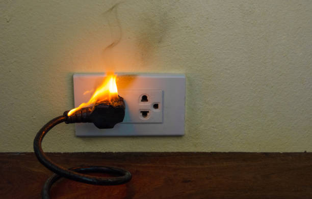 istock On fire electric wire plug Receptacle wall partition, Electric short circuit failure resulting in electricity wire burnt 1201795337