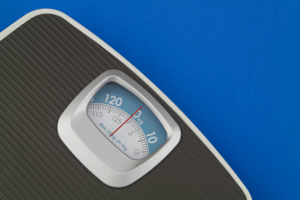 istock Scale on blue background with copyspace for text. Loose weight and overweight concept. 1201795623