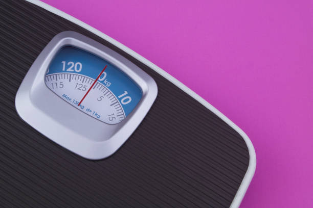istock Scale on pink background with copyspace for text. Loose weight and overweight concept. 1201796245