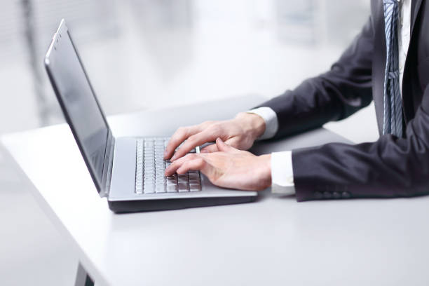 istock close up. businessman typing on laptop. people and technology 1201796405