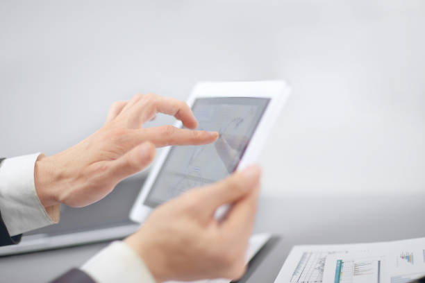 istock close up.businessman pointing at digital tablet screen 1201797343