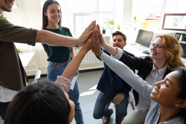 istock Staff giving high five congratulating each other with corporate achievement 1201798739