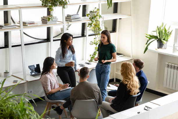 istock Concerned diverse office employees gather together solve business problems 1201798742