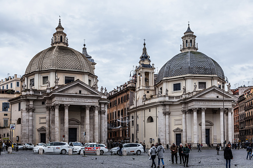 Rome, Italy - December 02, 2019:  People's Square ( Piazza del Popolo ), Churches of Santa Maria in Montesanto and Santa Maria dei Miracoli, Rome architecture and landmark, in  Rome, Italy