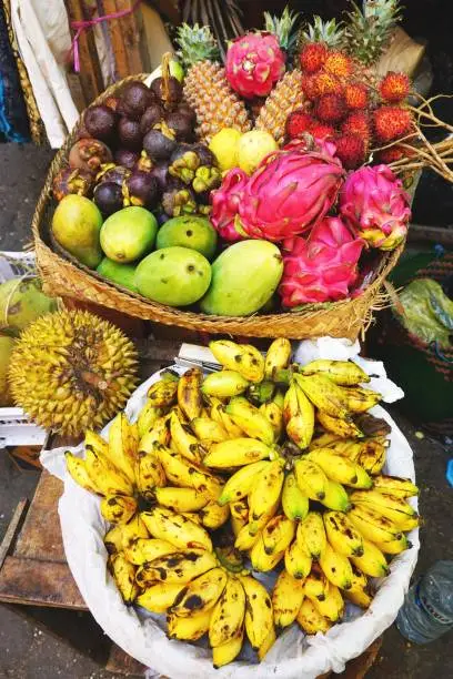 Photo of Baskets of fresh ripe tropical fruit for sale at a market in Bali Indonesia