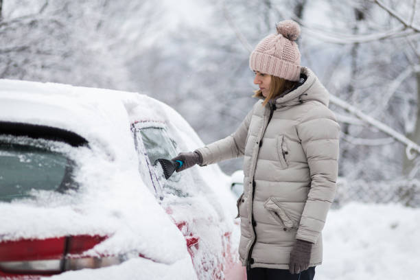 istock Woman cleaning car after winter attack 1201806365