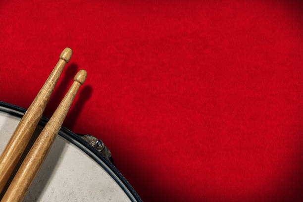 istock Drumsticks and snare drum on red velvet background - Percussion instrument 1201810978