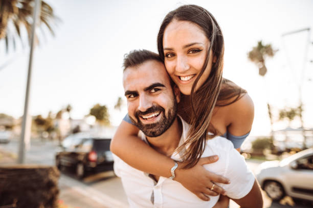 istock piggybacking couple at dusk on vacation 1201812172