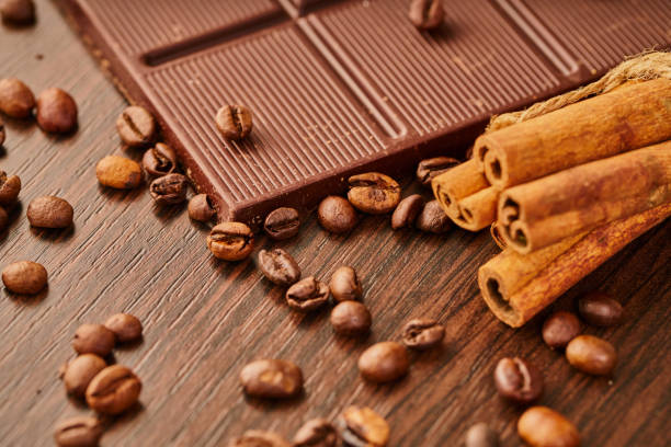 chocolate bar and coffee beans on wooden background