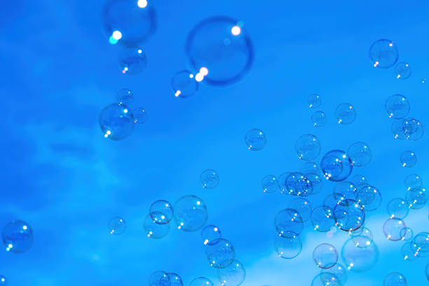 istock Soap bubbles soar in the blue sky. Abstract background texture which feels like dreams 1201817449