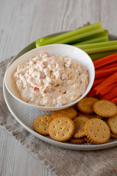 istock Homemade Pimento Cheese Dip with carrots, celery and crackers, low angle view. Close-up. 1201817617