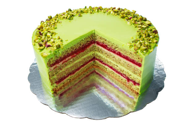 Cake with fruity cream and pistachio decorated with nuts, isolated on white background