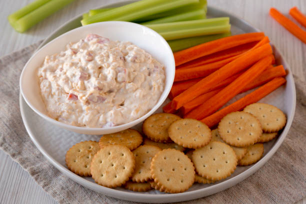 istock Homemade Pimento Cheese Dip with carrots, celery and crackers, side view. Close-up. 1201817669