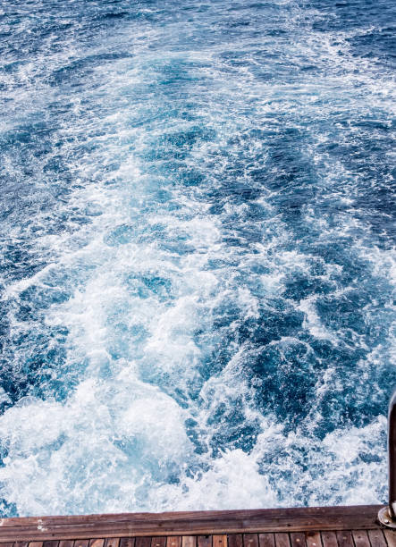 istock Cruise ship wake Wave ocean trace on blue sea water background. 1201817895
