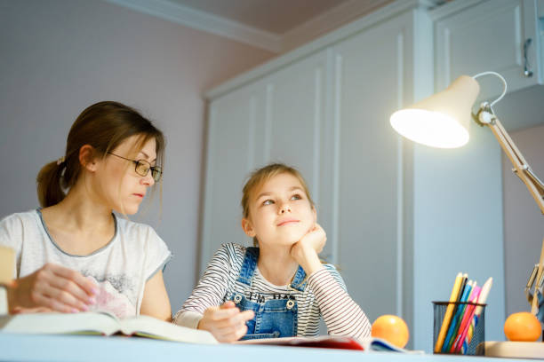 istock Mother and daughter doing homework together, styding and learning concept, doing tasks for school 1201818616