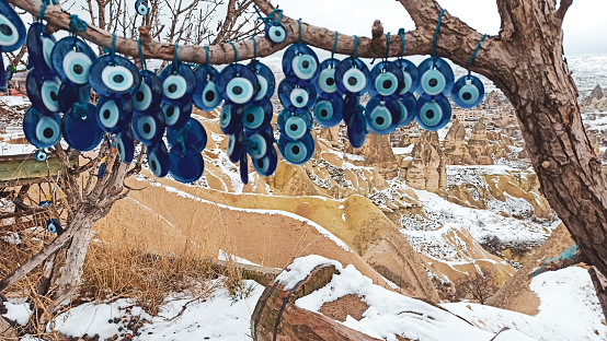 Blue Evil eye charms hang on the tree in Cappadocia, Turkey