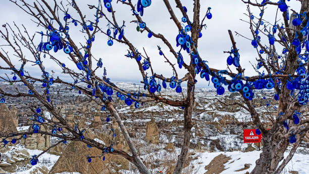 istock Blue Evil eye charms with snowy landscape in Cappadocia 1201819058