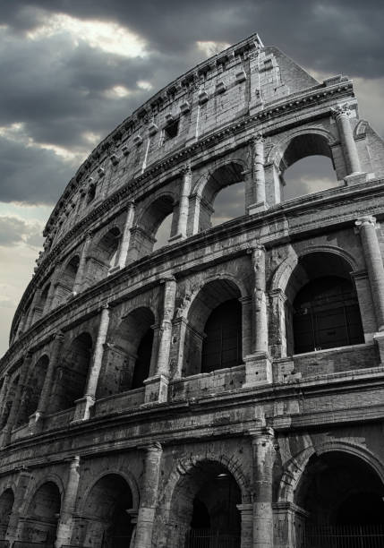Black and White Colosseum in Rome whit dramatic cloud sky in the background.