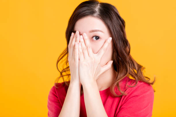 istock scared young asian woman with hand cover face 1201821520