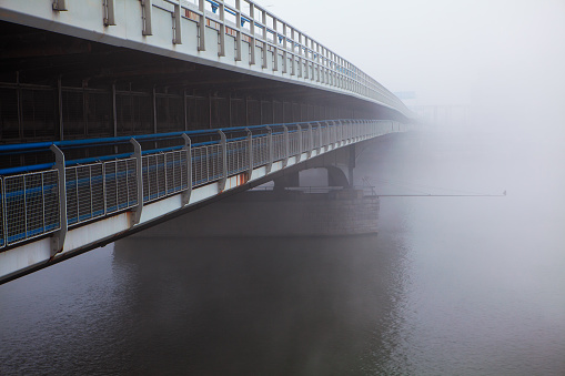 bridge over Danube river in the foggy day