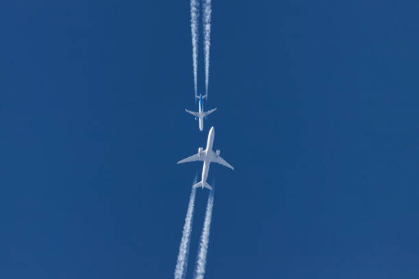 istock Two planes flying on opposite courses meet in the sky 1201824918