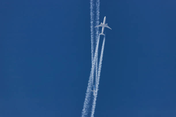 istock Two planes flying on opposite courses meet in the sky 1201824924