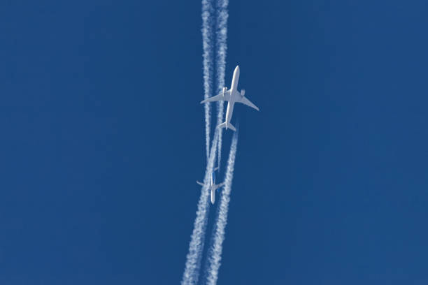 istock Two planes flying on opposite courses meet in the sky 1201824947