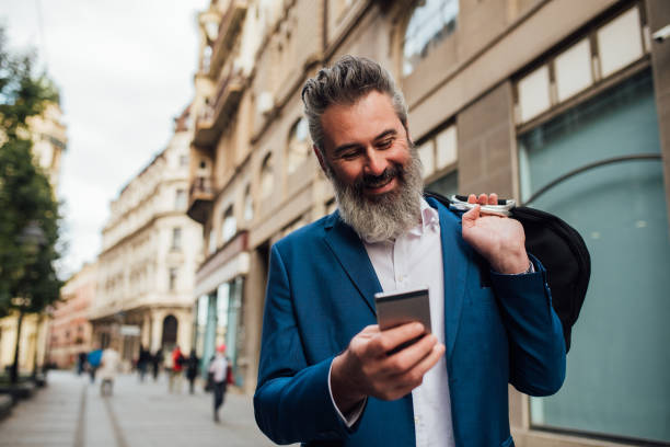 istock Mature businessman going to work and using a smartphone 1201828242