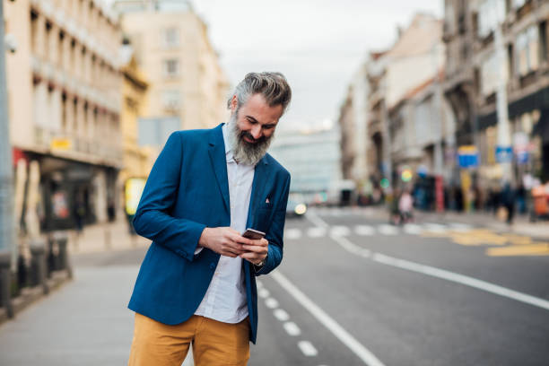istock Businessman using a smartphone on the street 1201828264