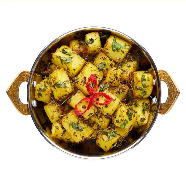 Aloo Methi in copper kadai, bowl isolated at white background. Aloo Methi is indian cuisine dish with Potato, Fenugreek and Spices. Indian Food. Isolate