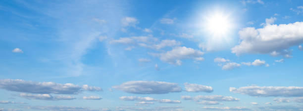 istock Beautiful blue sky with white clouds and sun, sunlight background 1201830726