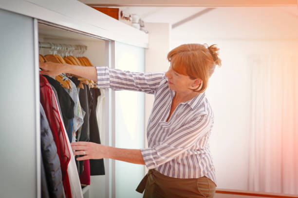 istock Woman choosing clothes from the wardrobe 1201830752