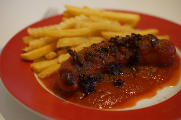 istock Currywurst with fries on a red plate 1201834136