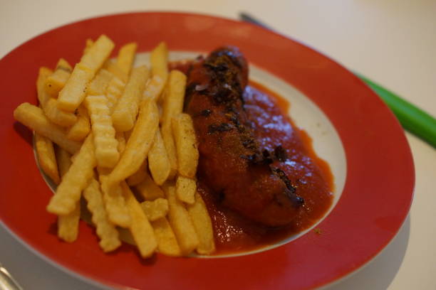istock Currywurst with fries on a red plate 1201834137