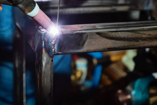 Female TIG welder welding steel