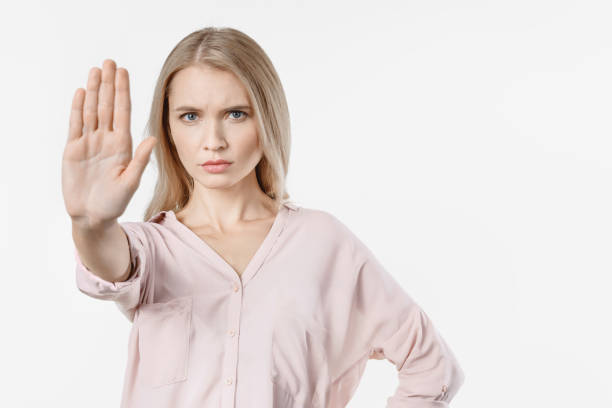 istock Angry woman gesturing stop sign over isolated white background 1201838183