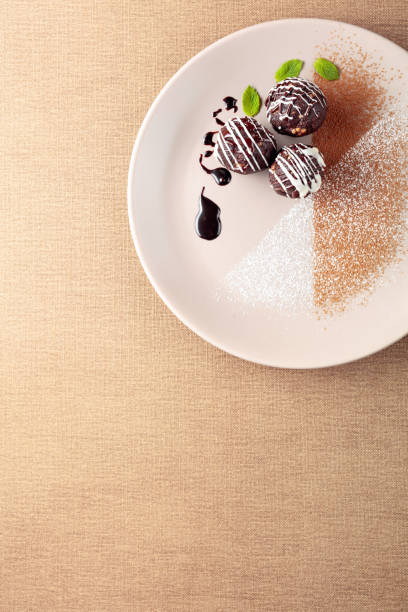 istock Chocolate balls with mint on a beige plate. 1201840518