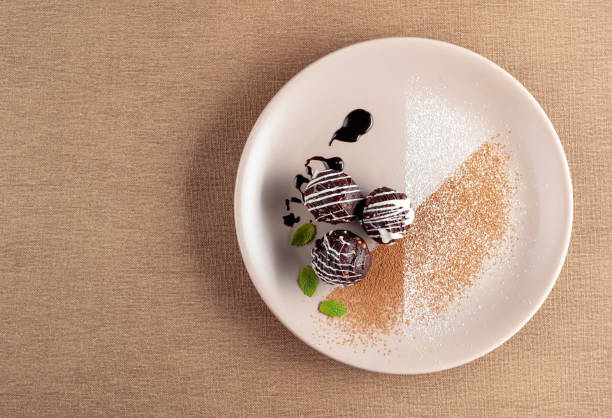 istock Chocolate balls with mint on a beige plate. 1201840522