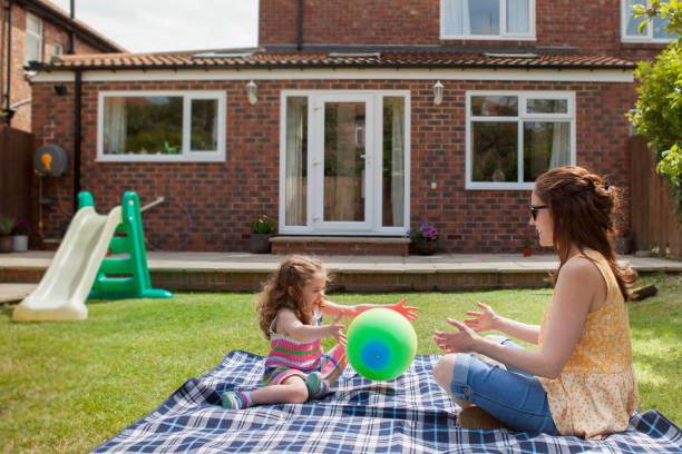 istock Mother and Daughter Playing in Garden 1201847571