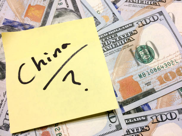 American cash money and yellow sticky note with text China with question mark American cash money and yellow sticky note with text China with question mark in black color aerial view philadelphia federal reserve stock pictures, royalty-free photos & images