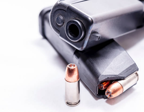istock A black 9mm semi automatic pistol with a loaded pistol magazine with a single 9mm hollow point bullet 1201851705
